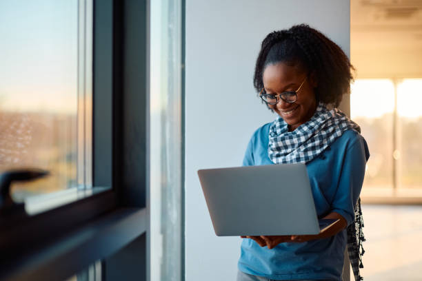 istock Happy black woman surfing the net on laptop. 2007105209