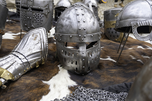 knight's old helmet with visor raised and chain mail for protection in battle. is made of metal. knight's armor.