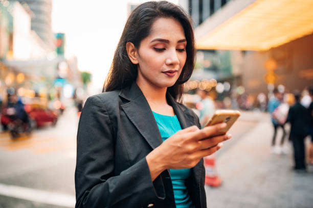 istock Business Woman using her Smart Phone in Downtown Kuala Lumpur 2007124831