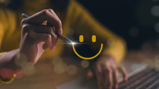 The consumer answered the survey conceptually. The customer creates a happy face smiling symbol using a digital pen. The notion of customer happiness and service experience.
