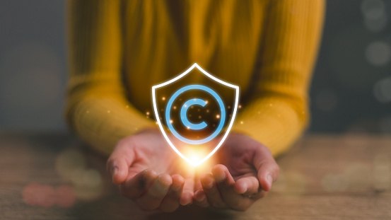 Copyright or patent concept, Women hand holding copyright icon with shield, Copyleft trademark license, Creation ownership against piracy crime