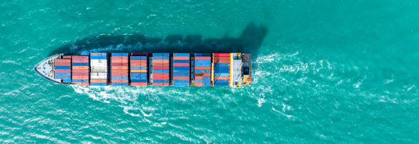 istock top view Cargo Container ship with contrail in the ocean ship carrying container and running for import export concept technology freight shipping by ship 2007157979