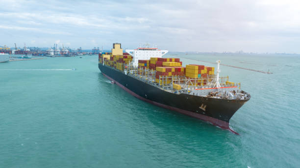 istock side view Cargo Container ship with contrail in the ocean ship carrying container and running for import export concept technology freight shipping by ship 2007158546