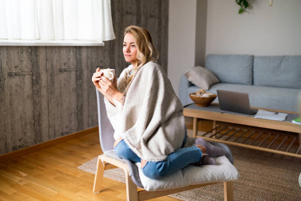 istock Serious woman drinking tea at home 2007160654