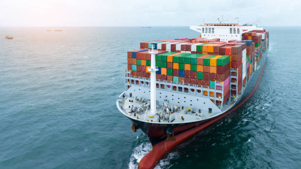 istock front view Cargo Container ship with contrail in the ocean ship carrying container and running for import export concept technology freight shipping by ship 2007163355