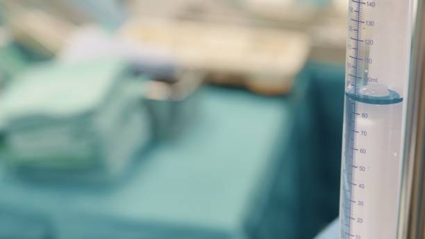 Portrait of confident female surgeon wearing scrubs in emergency room. Mature doctor is standing in operation theater. She is at hospital.