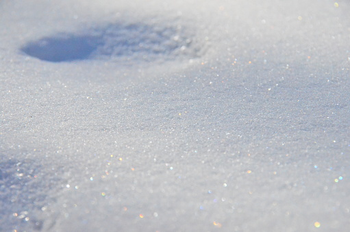 Snow surface with blurred background, glitter and crystals