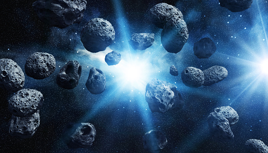 A cluster of asteroids floating in deep space with a radiant star illuminating the cosmic scene.