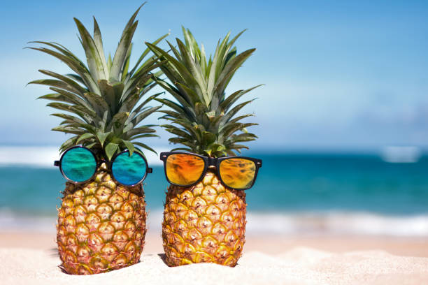 istock Two pineapples with trendy sunglasses in tropical paradise 2007222800