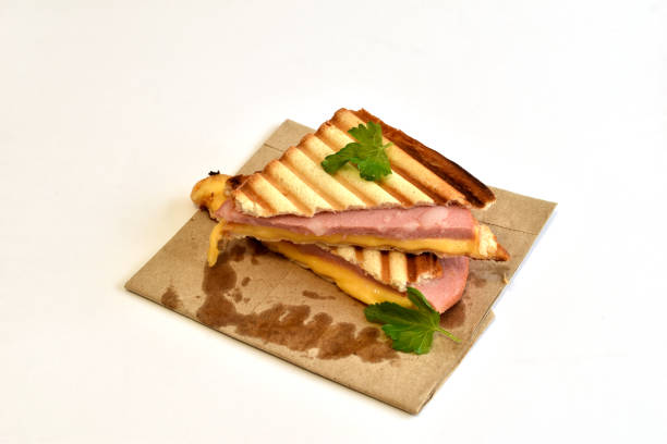Two ready-to-eat sandwiches with sausage and cheese.