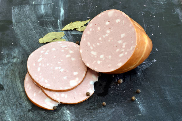 istock Thick sausage with pieces of fat on the table. 2007316544