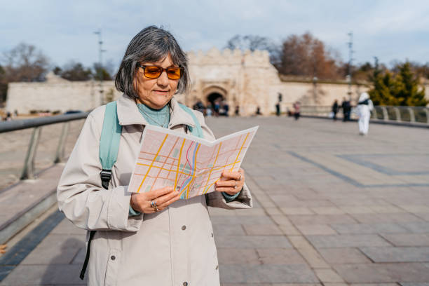 istock Senior Woman Reading A Map On The Bridge 2007317068