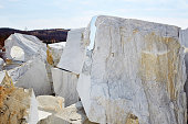 Large white marble blocks in an old abandoned quarry in the village of Buguldeika.