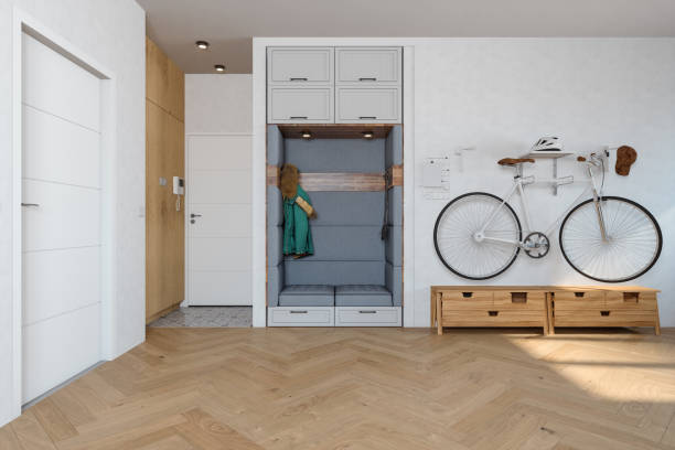Building Entrance With Coat Hook, White Cabinets, Hassock And Bicycle In Corridor.