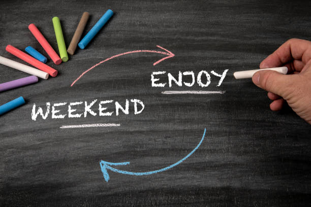 istock Enjoy your Weekend. Black scratched textured chalkboard background 2007336267