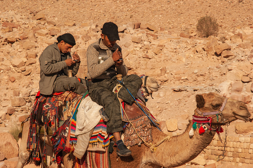 Jordan. Petra is ancient city carved into rocks. Nabateans on camels in ancient capital of Nabatean kingdom. Camels as means of transportation. Petra, Jordan - December 5, 2009