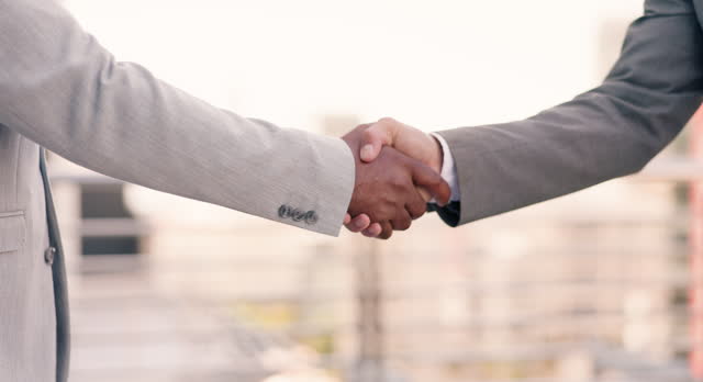 Shaking hands, business people and closeup in city, outdoor and meeting with respect for introduction. Corporate employees with handshake for kindness, welcome or hiring with agreement, deal or job