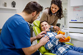 The dentist gains the trust of the smiling boy
