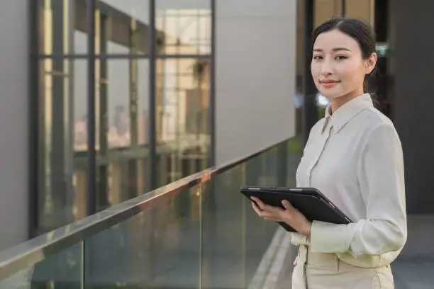 A young Asian woman on a balcony with a tablet, AI-generated.
