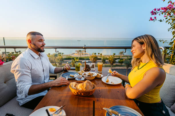 istock Young Couple Having Lunch In A Restaurant In Kuwait City 2007376447