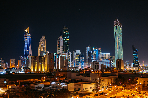 Panoramic view of Kuwait City skyline at night.