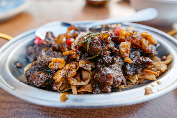 Lamb meat dish with nuts, pomegranate and dried figs in a diner in Kuwait City