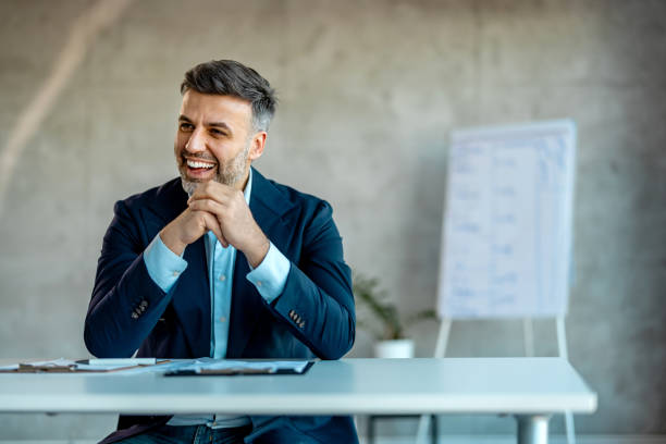 istock Satisfied young man in office looking away 2007427529