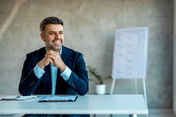 istock Business man looking outside the window in an office 2007427533