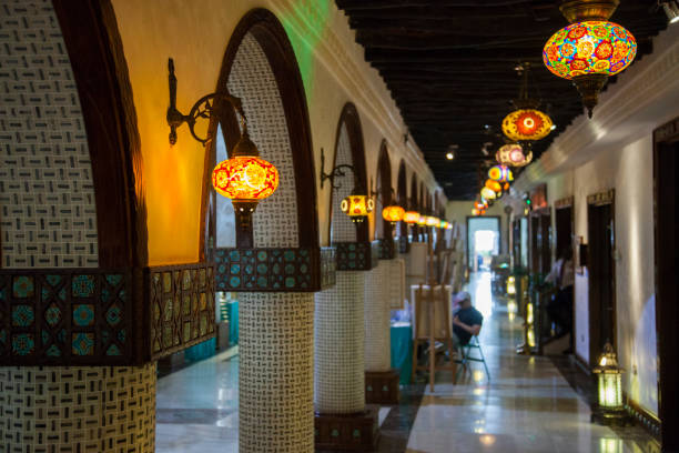 Doha, Qatar-April 20,2022: In the Old market Souk Waqif a decorative, traditional, glass mosaic lamps hanging.