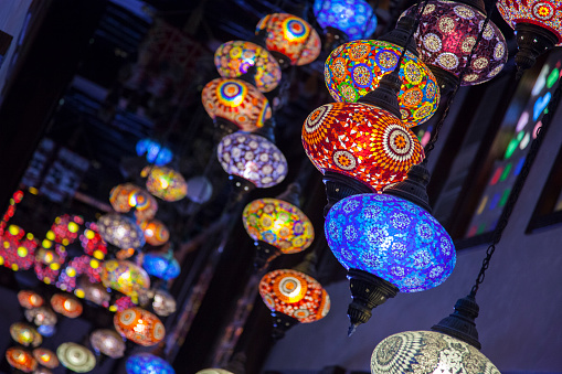 Doha, Qatar-April 20,2022: In the Old market Souk Waqif a decorative, traditional, glass mosaic lamps hanging.