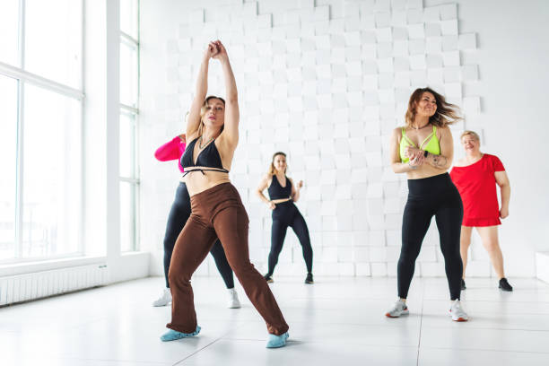 istock Small group of women dancing zumba in dancing room 2007486676