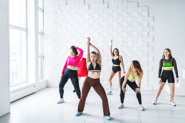 istock Small group of women dancing zumba in dancing room 2007487217