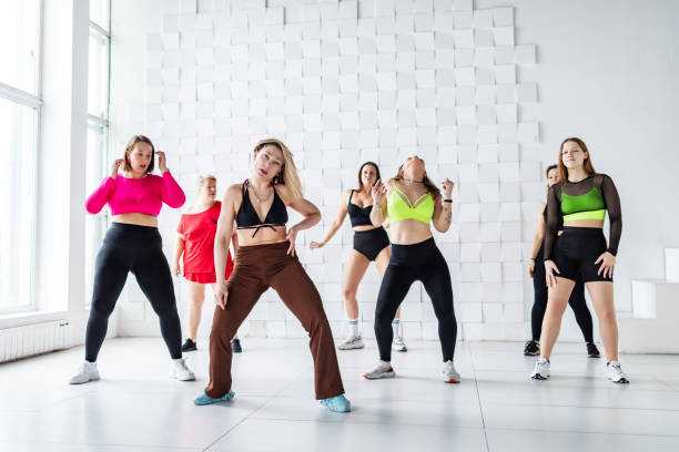 istock Group of women dancing zumba in dancing room 2007488812