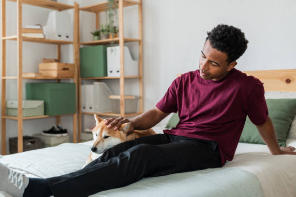 istock Relaxed Student Petting Dog at Home 2007492773