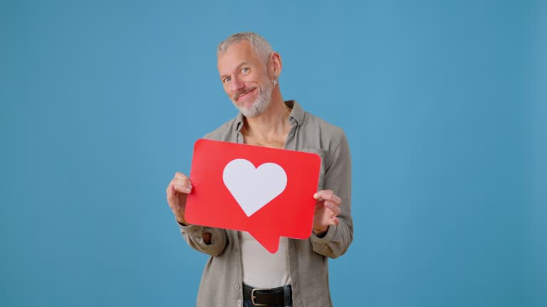 Man shows picture with heart shape as sign of supporting