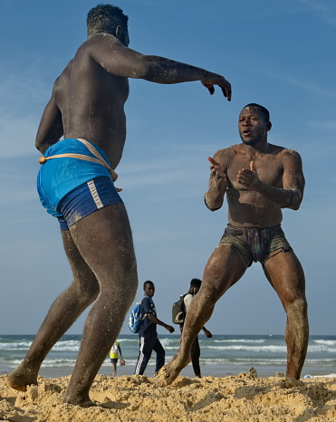 Dakar. Senegal. October 13, 2021. Two Senegalese wrestlers on the seashore participate in a national Laamb wrestling match. Laamb is the only martial art where blows are struck with bare hands.