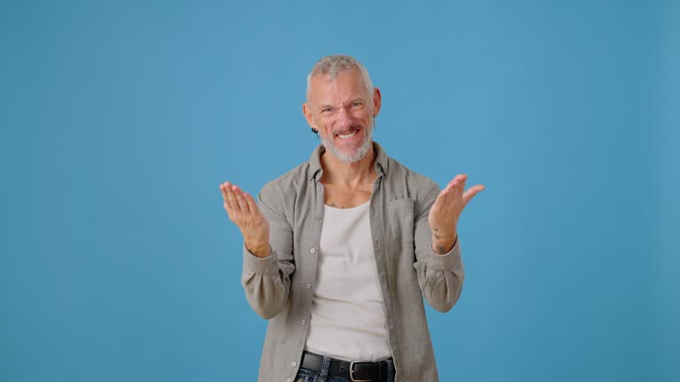 Energetic mature man showing thumbs up as sign of support
