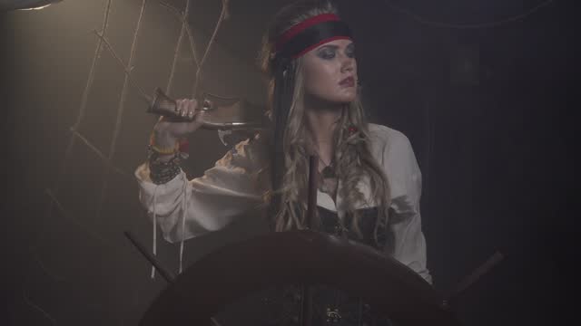 Pirate woman with a pistol is commanding on the ship, 4k