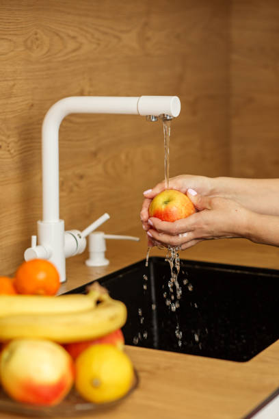 istock Washing an Apple Under Tap Water 2007557595