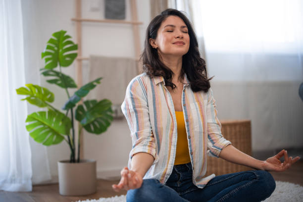 istock Beautiful woman practicing yoga at home 2007562353