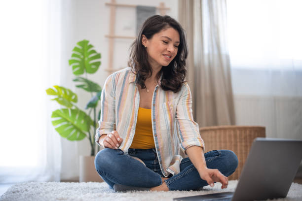 istock Beautiful woman practicing yoga at home 2007562395
