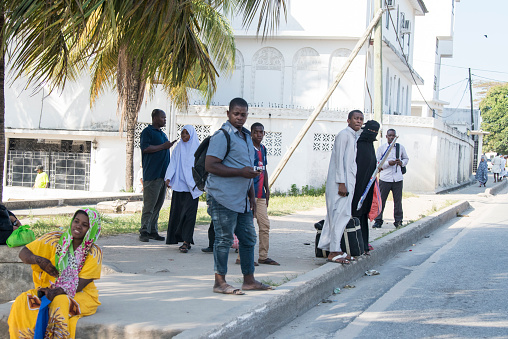 Zanzibar City, Tanzania - May 01,2023: Street view of the usual daily life of local people all ages taking place along the road on the Zanzibar Island.