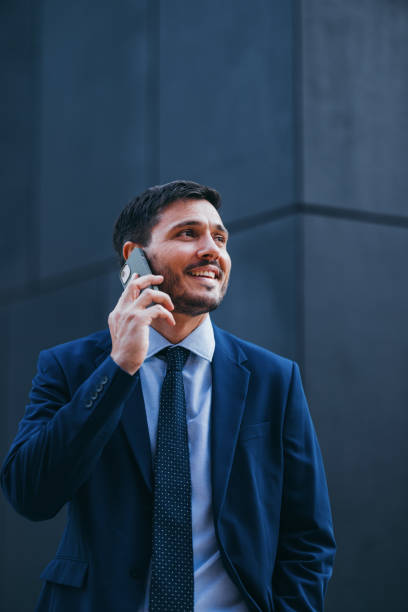 istock Handsome Businessman Having a Phone Call While Standing on the Street 2007575707
