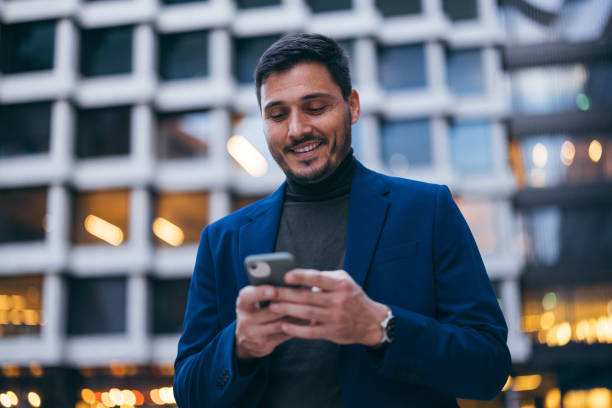 istock Handsome Man Outside the Office Texting on His Mobile Phone in the Evening 2007576265