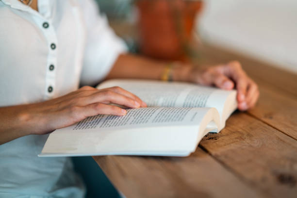 istock young woman reading a book in cafe 2007576810