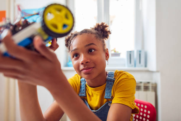 Young student with curly afro hair engaged in a STEM learning environment