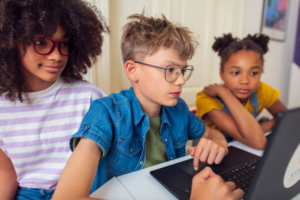 istock Diverse group of primary school students using laptops in the school 2007593883