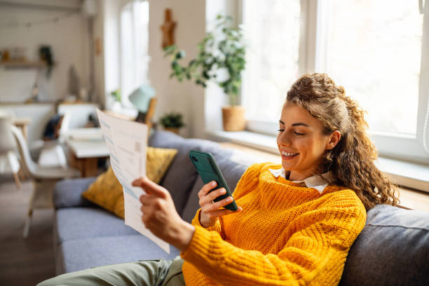 istock Woman using mobile phone to scan the QR code and paying the bill 2007594417