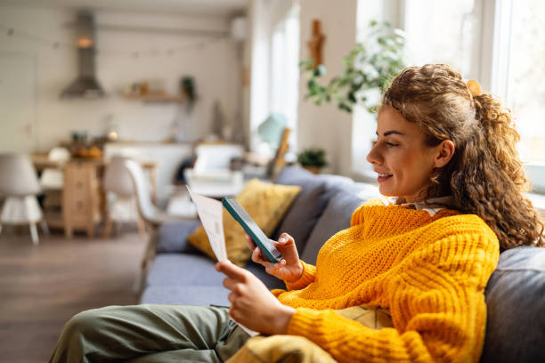 istock Young woman using e-banking to pay bills from home 2007594446