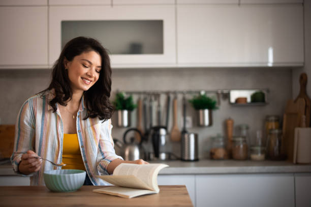 istock Young woman reading at home 2007594983